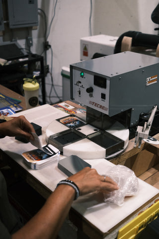Worker assembling Mylar magnets in the factory production process